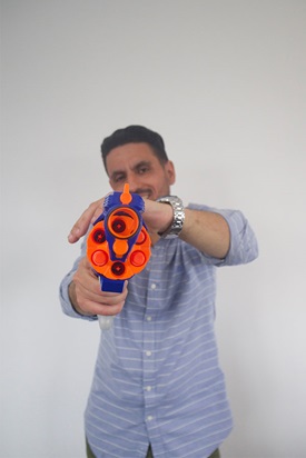 Man pointing a nerf gun